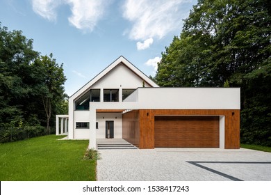 New White House With Cobblestone Driveway And Garage With Wooden Elevation