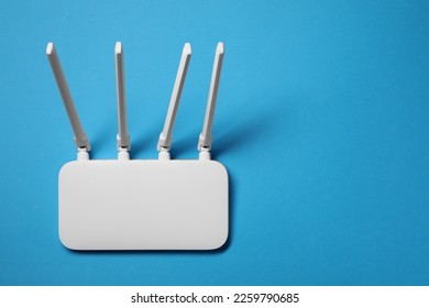 New white Wi-Fi router on light blue background, top view. Space for text - Shutterstock ID 2259790685