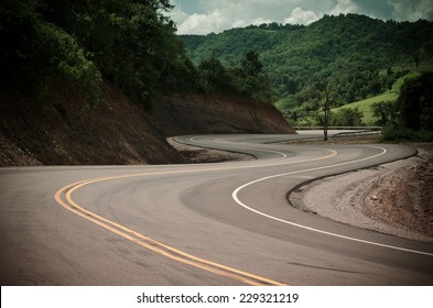 New winding road in the mountain - Shutterstock ID 229321219