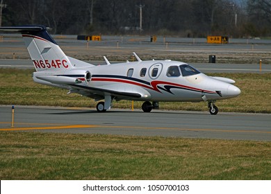 NEW WINDSOR, NEW YORK - APRIL 11, 2017: A 2008 Eclipse Aviation EA500 taxiing off the runway of Stewart International Airport. This airplane is a twin turbofan jet.