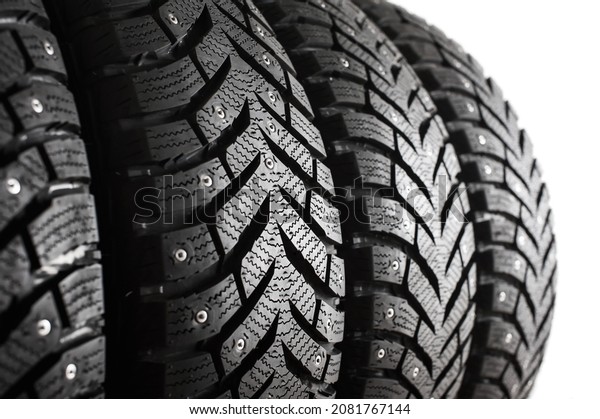 New winter tires with studs close-up. Tire\
tread. Set of winter car tires.\
defocus