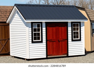new wood sheds on display the shed is typically used as outdoor storage and commonly located in home backyard store grey front