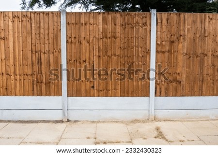 New wooden closeboard fence installation featuring concreate gravel boards