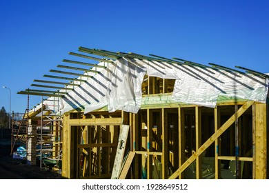 New Wooden Construction Building In The Construction Process, Roofing With Waterproofing Film