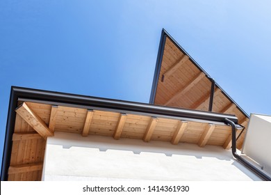 New Wooden Warm Ecological House Roof With Steel Gutter Rain System. Professional Construction And Drainage Pipes Installation. Eco Materials.




