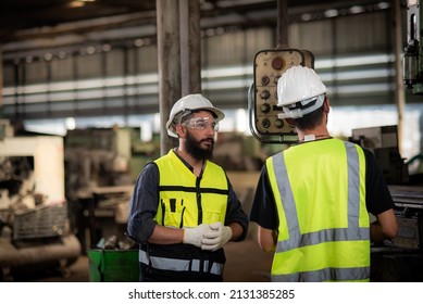 A New Worker, Latin Mix Race Man Worker Have Unkempt Beard In Safety Uniform Is Being Training On The Job Or Coaching From A Supervisor To Control The Heavy Machine In Industrial Manufacturer Factory.