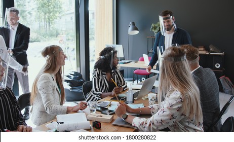 New Workplace Safety Standards After COVID-19 Lockdown. Multiethnic Business People Team Meeting At Light Modern Office.