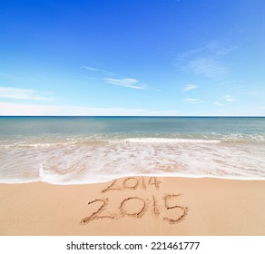 New Year 2015 is coming concept - inscription 2014 and 2015 on a beach sand, the wave is covering digits 2014 - Powered by Shutterstock