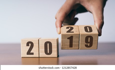 New year 2019 change to 2020 concept, hand change wooden cubes