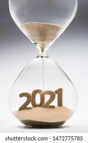 New Year 2021 concept with hourglass falling sand taking the shape of a 2021 - Shutterstock ID 1472775785