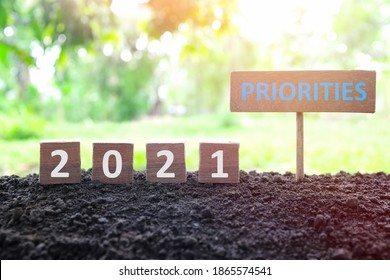 New Year 2021 Life Goals, Resolution And New Priorities Concept. Wooden Blocks Dice On A Natural Background At Morning Sunrise.