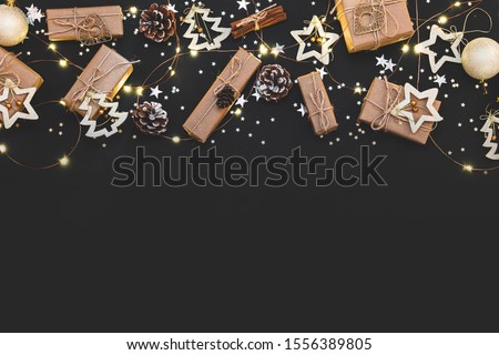 New year 2021. Merry Christmas and Happy Holidays greeting card. Christmas composition. Gold and silver decorations on black background. Winter, new year concept. Flat lay, top view