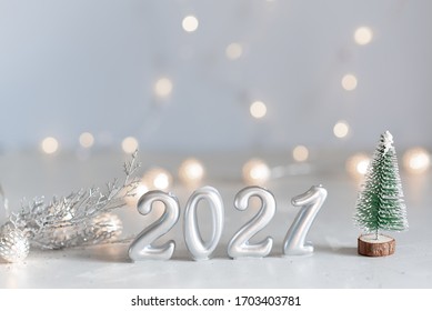New Year 2021 silver balloons with fireworks. Blurred lights in the background - Shutterstock ID 1703403781