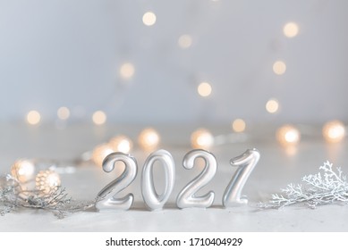 New Year 2021 silver balloons with fireworks. Blurred lights in the background - Shutterstock ID 1710404929