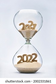 New Year 2022 concept with hourglass falling sand taking the shape of a 2022 - Shutterstock ID 2002331861