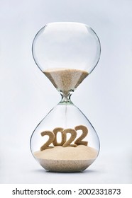 New Year 2022 concept with hourglass falling sand taking the shape of a 2022 - Shutterstock ID 2002331873