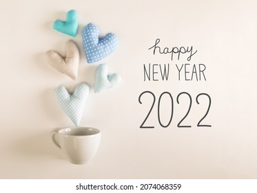 New Year 2022 Message With Blue Heart Cushions Coming Out Of A Coffee Cup