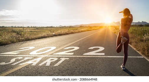 New year 2022 or straight forward concept.Word 2022 written on the road in the middle of asphalt road at sunset.Concept of planning and challenge,hope,new life change,business strategy,opportunity  - Shutterstock ID 2088664948