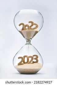 New Year 2023 concept with hourglass falling sand taking the shape of a 2023 - Shutterstock ID 2182274927