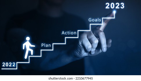 New Year 2023 with plan, action and goals.Businessman pointing to the growing plan of successful business in 2023 year and a figure climbs the ladder of success.  - Shutterstock ID 2210677945
