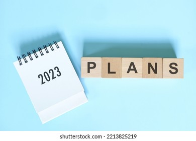 New year 2023 plans concept. Desk calendar flat lay in blue background. - Shutterstock ID 2213825219