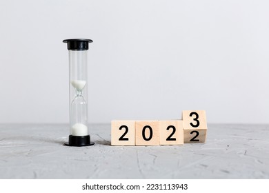 New Year 2023 sand timer. Resolution, time, plan, goal, motivation, reboot, countdown and New Year holiday concepts. Hourglass with number 2023.