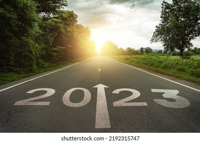New year 2023 or straightforward concept. Text 2023 written on the road in the middle of asphalt road at sunset.Concept of planning and challenge, business strategy, opportunity ,hope, new life change
