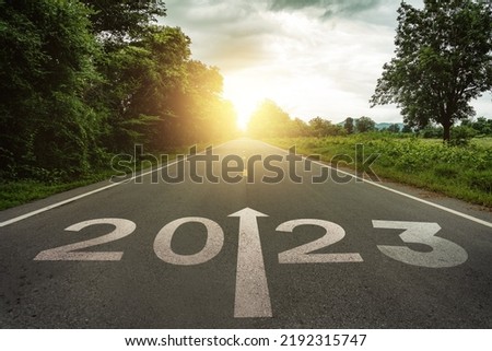 New year 2023 or straightforward concept. Text 2023 written on the road in the middle of asphalt road at sunset.Concept of planning and challenge, business strategy, opportunity ,hope, new life change