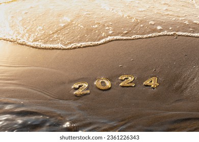 New year 2024 background. 2024 numbers on wet golden sand of beach in sun rays light and rolling sea wave. Celebration New Year's Eve holidays at seaside resort, travel, change, new beginning, vision - Powered by Shutterstock