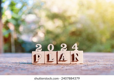 New Year 2024 business plan, strategies, goal, development and success. 2024 number and text plan on wooden cubes.