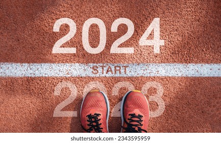 New year 2024 concept, beginning of success. Text 2024 written on asphalt road and male runner preparing for the new year. Concept of challenge or career path and change. - Shutterstock ID 2343595959
