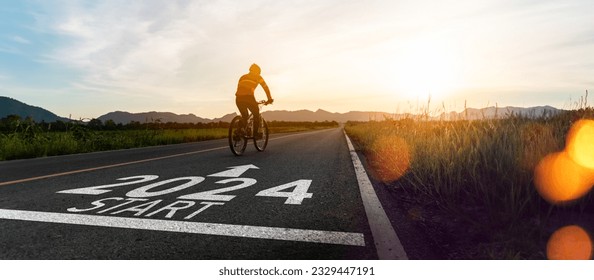 New year 2024 or start straight and beginning concept.silhouette of Blurry Man ride on bike and word 2024 start written on the road at sunset.Concept of challenge or career path,business strategy. - Powered by Shutterstock