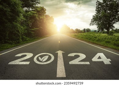 New year 2024 straightforward for environmental sustainability concept. Text 2024, save the world, environment protection icon on the road in the middle of asphalt road at sunset. Ecological balance. - Shutterstock ID 2359492739