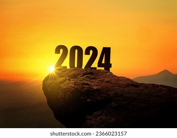 New Year 2024 at sunset. Silhouette 2024 stands on a mountain with sun rays at sunrise, creative idea. Year 2024, concept