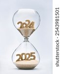 New Year 2025 concept with hourglass falling sand taking the shape of a 2025