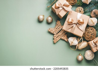 New Year card with Christmas gift boxes and golden decorations on khaki background. - Shutterstock ID 2205492835