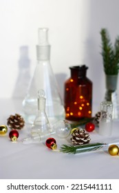 new year in the chemical laboratory. holidays at work. chemical dishes on the table with cones, Christmas tree, Christmas toys, garland. - Shutterstock ID 2215441111