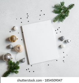 New Year Or Christmas Decor And Blank White Magazine Cover Mock Up On Light Background. Flat Lay. Top View. Copy Space