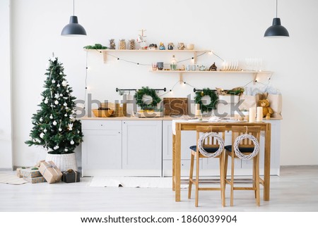 New year and Christmas. Festive Scandinavian cuisine in Christmas decorations. Candles, fir branches, wooden stands, table.