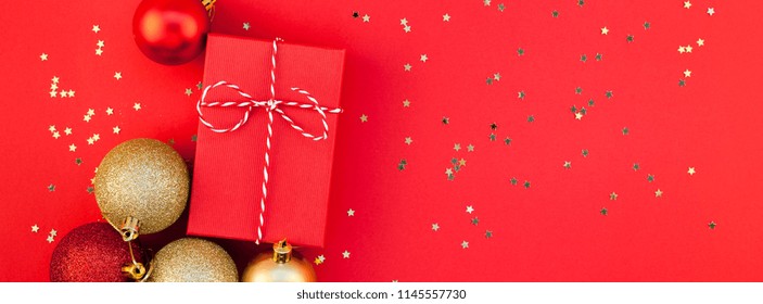 New Year Christmas presents wrapped ribbon flat lay top view Xmas holiday 2019 celebration handmade gift boxes red paper golden sparkles background copyspace. Template mockup greeting long wide banner