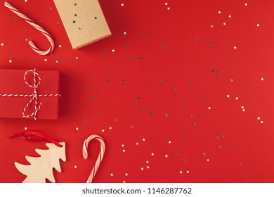 New Year Christmas presents wrapped ribbon flat lay top view Xmas holiday 2019 celebration handmade gift boxes red paper golden sparkles background copyspace. Template mockup greeting card text design