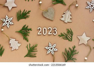 the new year is coming. wooden numbers 2023. Christmas decorations made of eco-friendly materials. toys made of wood, paper, cardboard. - Shutterstock ID 2213506169