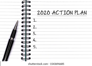 New Year Concept - 2020 Action Plan Text On Notepad With Pen.