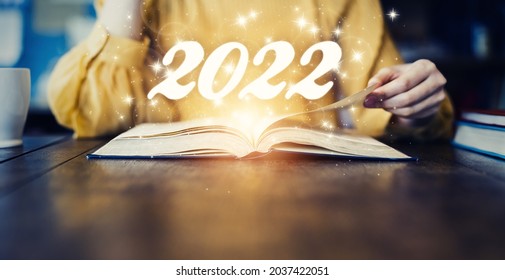 New Year Concept Of 2022. Woman Reading A Book. New Year Card.