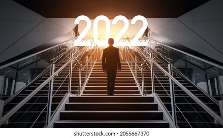 New year concept of 2022. New year's card. Businessman on the staircase.