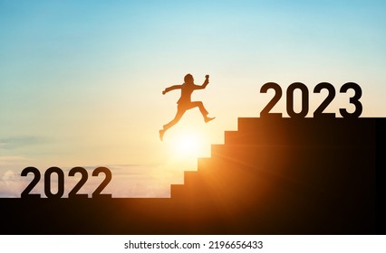 New year concept of 2023. New year's card. Silhouette of a man running up the stairs.