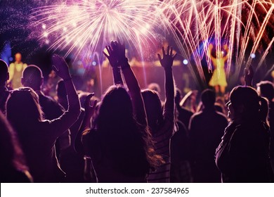 New Year concept - cheering crowd and fireworks 