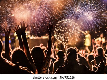 New Year concept - cheering crowd and fireworks - Shutterstock ID 506751328