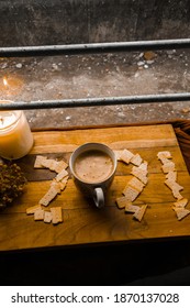 New Year Concept, A Cup Of Coffee And Some Crackers In Small Slices On Wooden Board