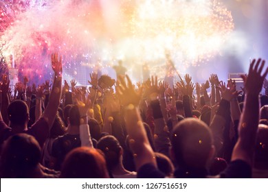 New Year concept - fireworks and cheering crowd celebrating the New year - Shutterstock ID 1267516519